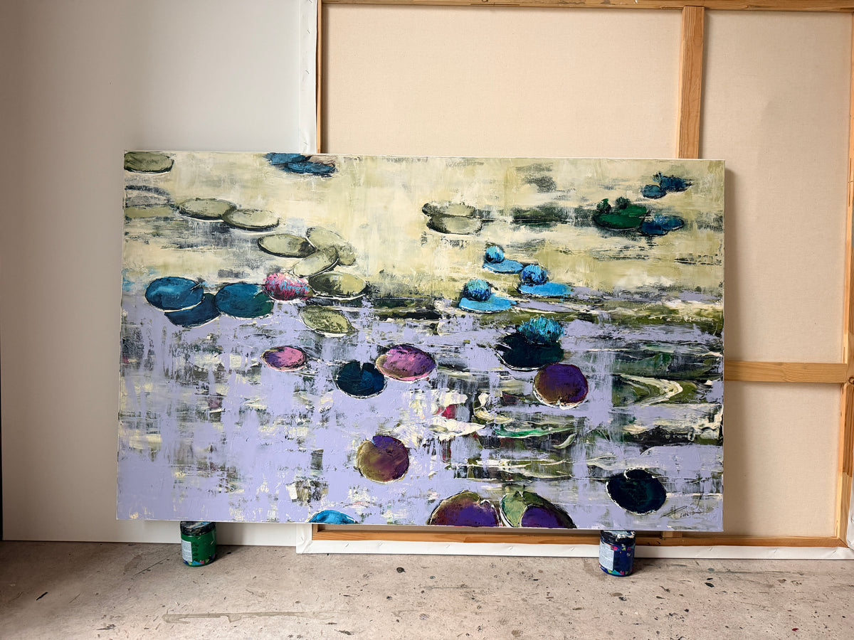 Front view of a massive original water lilies oil painting showcasing rich impasto palette knife textures. The large horizontal fine art canvas with vibrant violet and emerald colors stands on paint cans in a professional art studio from Ukraine.