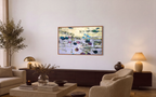 Oversized horizontal impressionist nature painting framed in wood, styled inside a warm organic modern living room. The textured purple fine art masterpiece hangs above a long dark wood console cabinet decorated with elegant designer ceramics.
