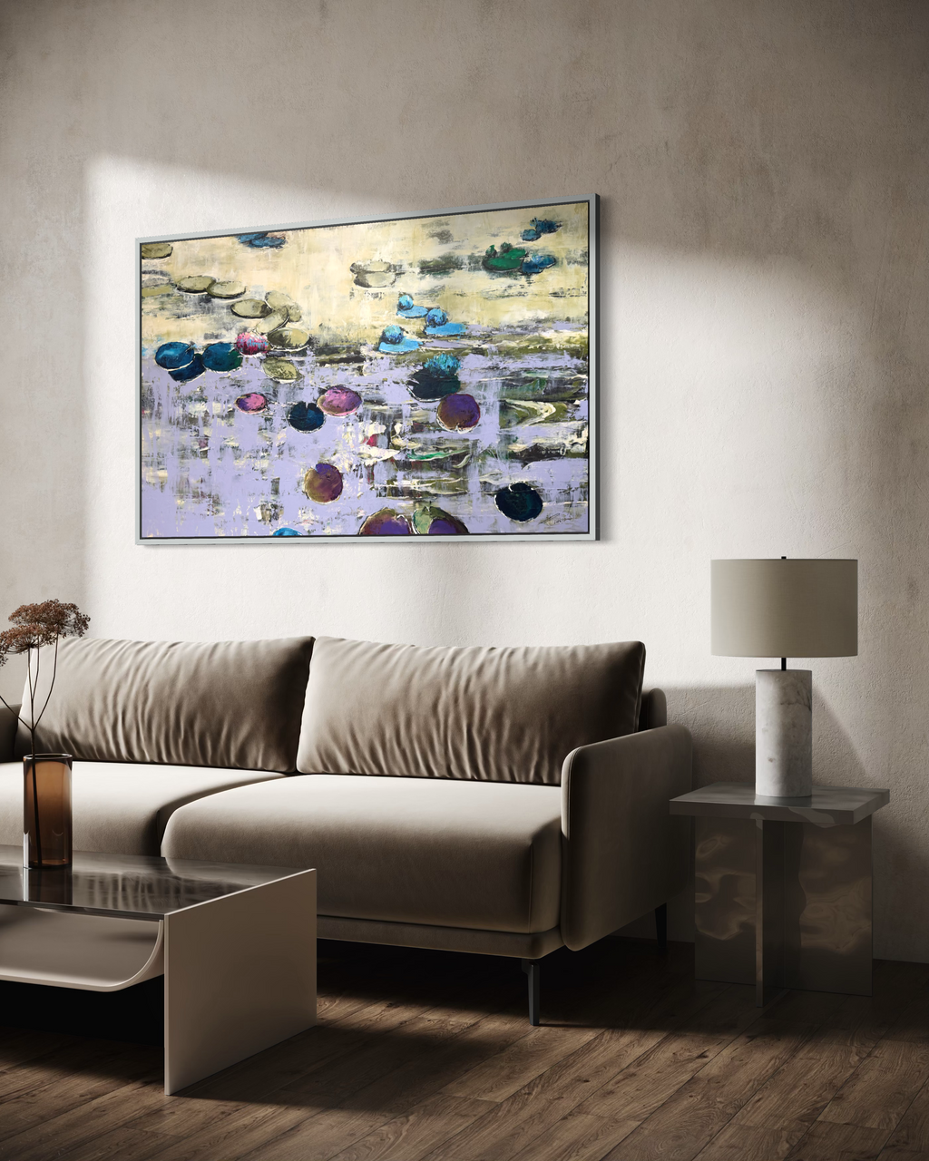 Modern luxury living room interior featuring an oversized purple water lilies canvas artwork in a silver frame. A premium velvet taupe sofa stands on rich dark hardwood floors under dramatic natural sunlight shadows next to a marble side table.