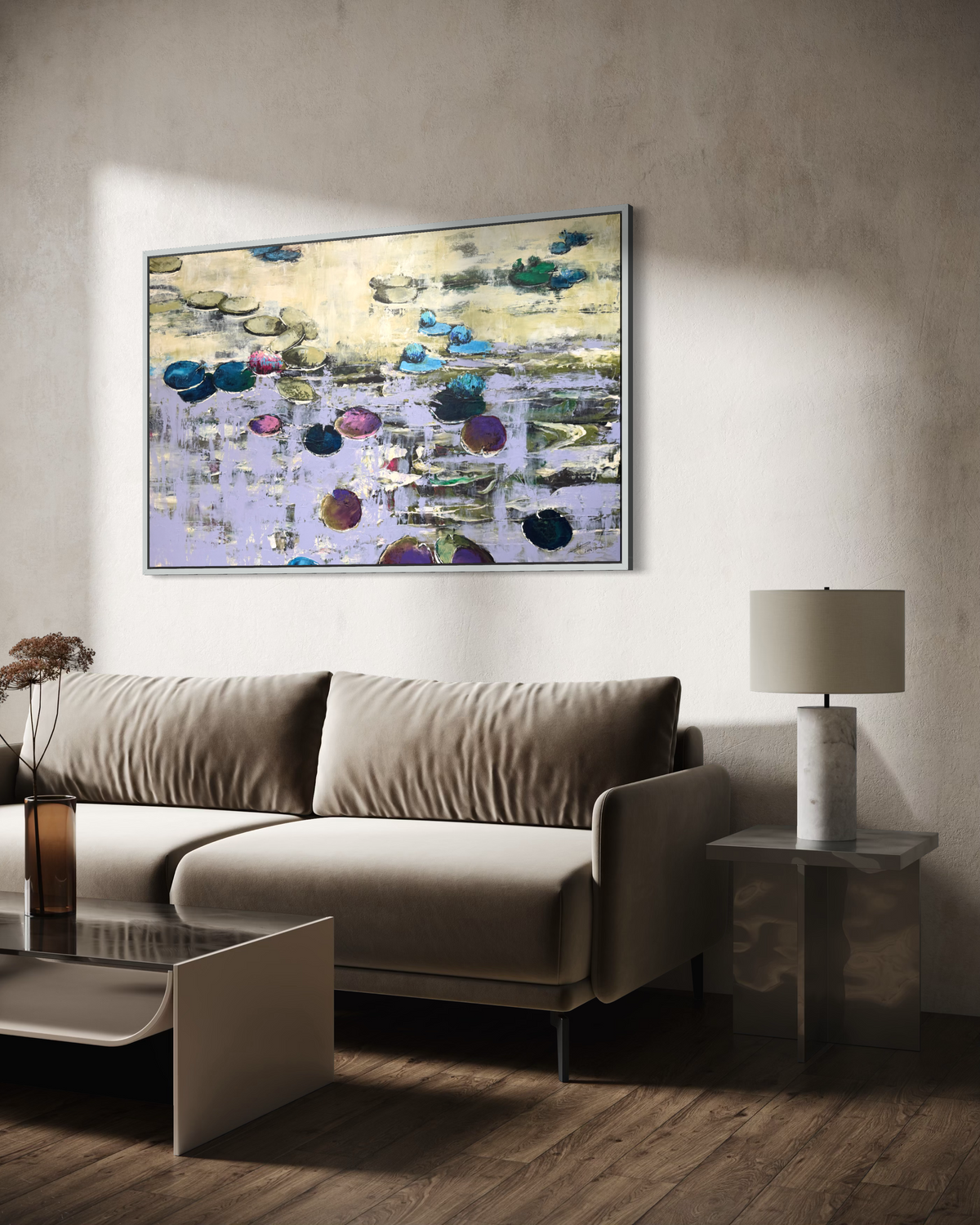 Modern luxury living room interior featuring an oversized purple water lilies canvas artwork in a silver frame. A premium velvet taupe sofa stands on rich dark hardwood floors under dramatic natural sunlight shadows next to a marble side table.