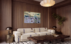 Luxury living room interior design featuring a large horizontal water lilies painting in a gold frame. The statement artwork is beautifully displayed on a dark walnut wood wall with elegant molding panels above a high-end designer sofa and a unique geometric dark wood coffee table.
