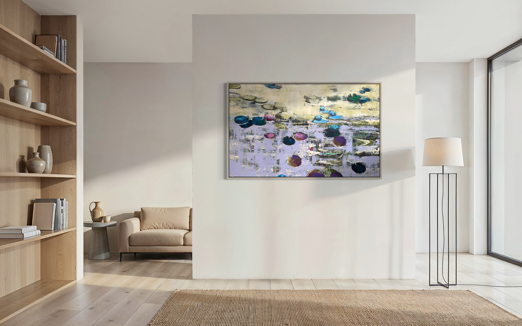 A grand, oversized horizontal fine art painting from Hutsul Art Gallery displayed on a central wall in a luxury minimalist home. The framed water lilies canvas stands out in a vast, open-space interior with light wooden floors, a designer shelf, and a floor lamp.